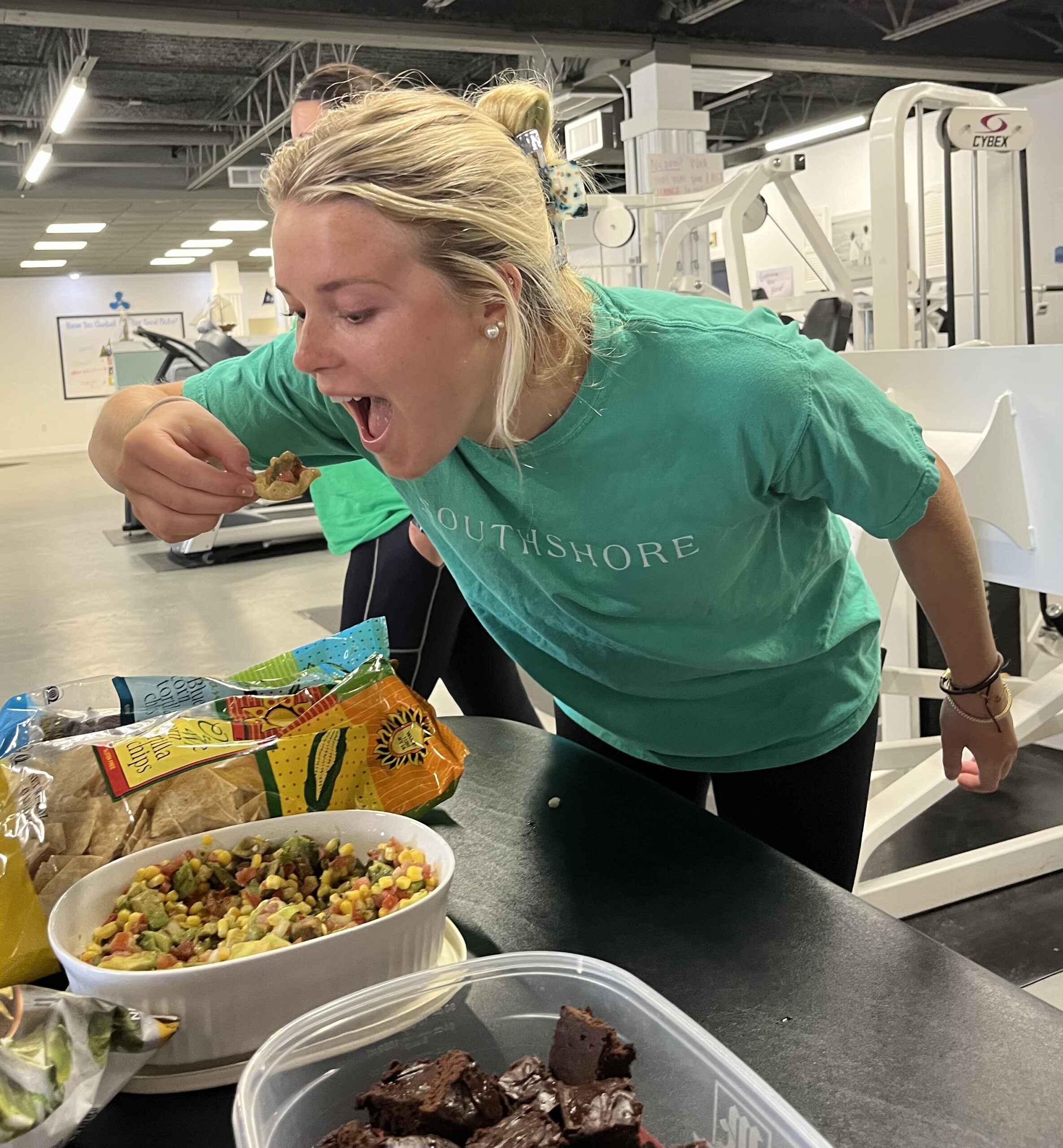 Southshore-Physical-Therapy_Metairie-Louisiana_National-Avocado-Day_green-clothes_smiling-girl-eating-avocado-dip_Brooke-Couret